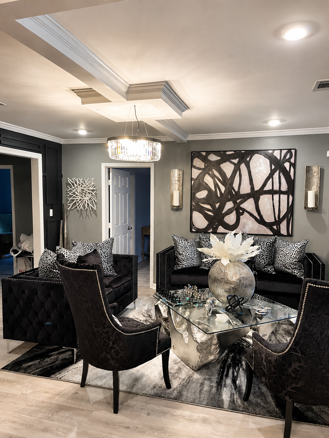 Black Room Residence living room with black velvet sofas and crystal chandelier