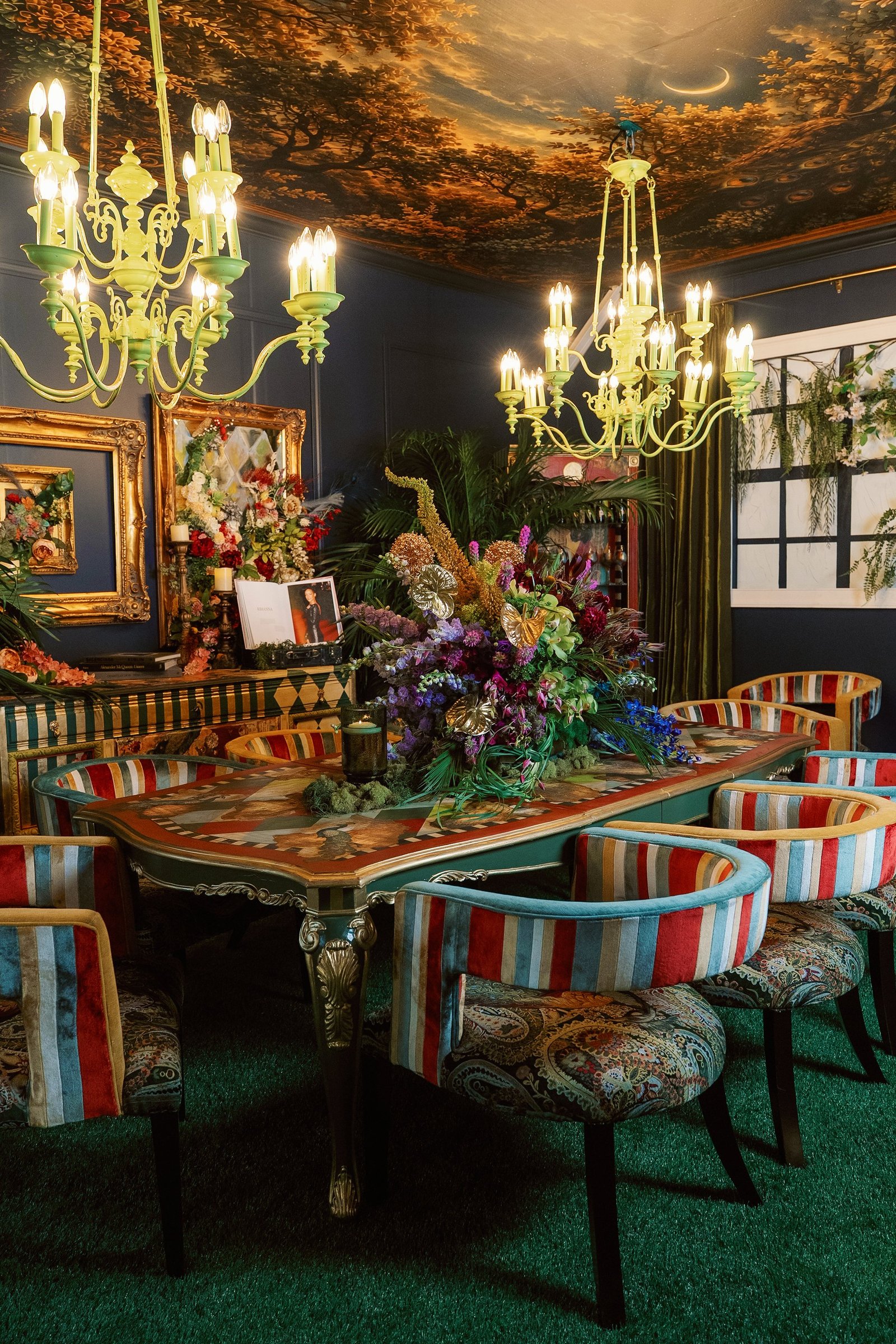 Three-quarter view of the dining table and chairs highlighting striped velvet upholstery