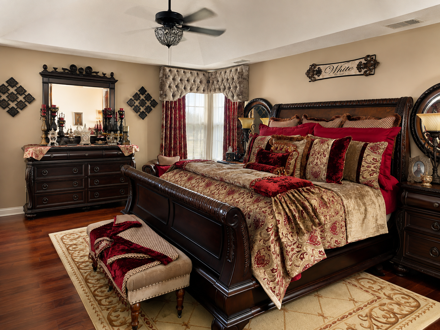 Full bedroom view showcasing matching dresser and mirror set, sleigh bed, and custom tufted window treatments